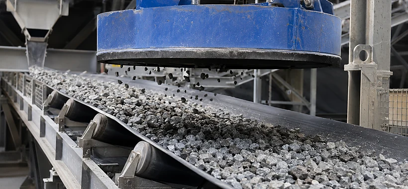 Magnetic separator installed above a conveyor for tramp iron removal
